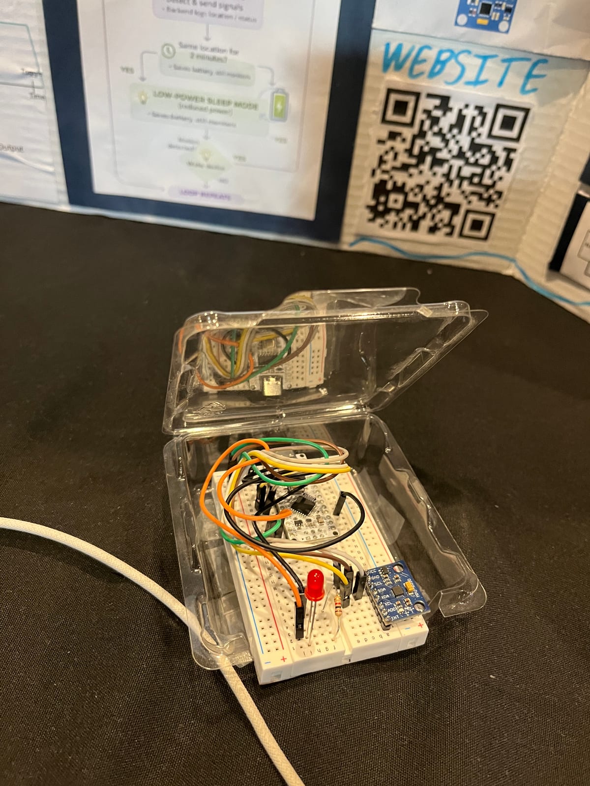 Breadboard prototype in a clear case: an MPU-6050 accelerometer, an Arduino microcontroller, a red LED, and jumper wires
